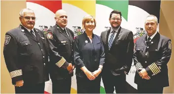  ??  ?? MPP Mike Harris met with Minister of Labour Laurie Scott at the Ontario Associatio­n of Fire Chiefs’ annual general meeting in Niagara Falls. Pictured are Woolwich fire chief Dale Martin, North Dumfries chief Robert Shantz, Scott, Harris, and Wilmot fire chief Rod Leeson.