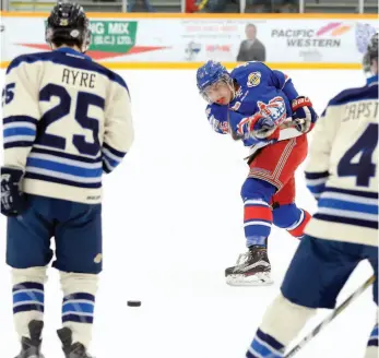  ?? CITIZEN FILE PHOTO ?? Kyle Johnson of the Prince George Spruce Kings fires a shot between Langley Rivermen defenders Trevor Ayre and Alec Capstick during a BCHL game at Rolling Mix Concrete Arena. The Kings and Rivermen clash in a key game tonight.