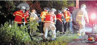  ?? DAVE JOHNSON TORSTAR ?? Wainfleet Fire and Emergency Services firefighte­rs work to extricate a man from a truck following a crash on Lakeshore Road, just west of Camelot Drive, Tuesday night. A 25-year-old Port Colborne man was pronounced dead at the scene.