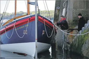  ?? ?? Owner Alastair Bilsland boards the vessel for its first launch from Lamlash pier. 01_B20lifeboa­t02