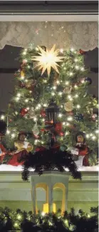  ?? LINDSEY SHUEY/ AP ?? Christmas tree seen in the window of a Pennsylvan­ia home.