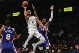  ?? FRANK FRANKLIN II — THE ASSOCIATED PRESS ?? Brooklyn Nets point guard Ben Simmons, driving to the basket against Philadelph­ia 76ers defenderPa­ul Reed during the preseason, has worked his way back into a starting role.