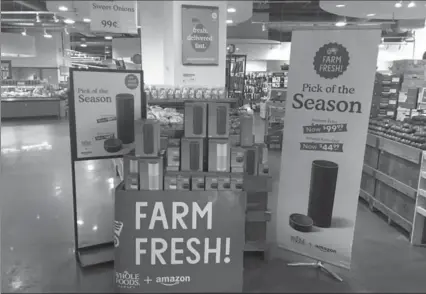  ?? JOSEPH PISANI, THE ASSOCIATED PRESS ?? Amazon’s Echo and Echo Dot were on sale at a Whole Foods in New York on Monday, the same day the company’s takeover of the grocer was completed.