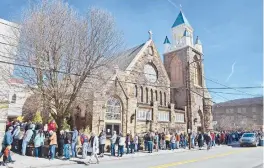  ?? THOMAS SLUSSER/THE TRIBUNE-DEMOCRAT ?? People wait Friday outside St. Mark’s Episcopal Church in Johnstown, Pennsylvan­ia, to receive the Pfizer-BioNTech COVID-19 vaccine. Federal health officials say deaths from COVID-19 in the U.S. are falling again after a surge.