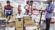  ?? PHOTO: REUTERS & BLOOMBERG ?? A Walmart store in Hyderabad ( top). The retailer is gearing up to open two to three more cash-and-carry outlets in Hyderabad ( top). Amazon set up India’s biggest fulfilment centre, spread over 400,000 sq ft with close to 2.1 million cubic feet of...