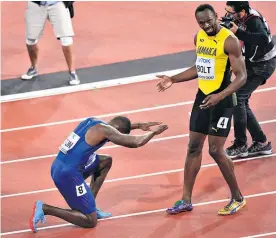  ?? Picture / AP ?? Justin Gatlin bowed down before Usain Bolt after the final.