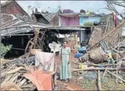  ?? PTI ?? A woman stands near the debris of her house that was damaged by Cyclone Titli in Andhra Pradesh’s Srikakulam on Friday.
