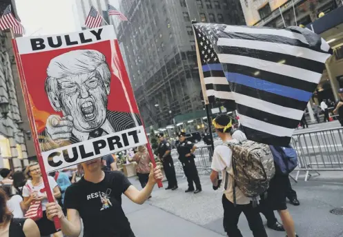  ??  ?? 0 Activists gather near Trump Tower in New York to protest against the policies of US President Donald Trump