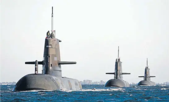  ?? Photo: REUTERS ?? Royal Australian Navy submarines, from left, HMAS Dechaineux, HMAS Waller and HMAS Sheean leave in formation from the Royal Australian Navy base HMAS Stirling, located near Perth. Defence planners want to replace the ageing vessels with advanced...