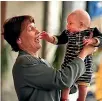  ?? PHOTO: MARK ROUND/STUFF ?? Helen Clark holds up Max Long during a photo opportunit­y with the Plunket Society in Wellington in 1999.