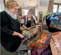  ?? PHOTO: DAVID UNWIN/FAIRFAX NZ ?? Christine Hartigan and Helen Pedersen, sort through quilts in preparatio­n for the Rose City Quilters biennial exhibition.