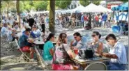  ?? TOM KELLY III — FOR DIGITAL FIRST MEDIA ?? Area residents sat under a group of trees in Smith Family Plaza last year to enjoy food during the 14th annual Pottstown Carousel of Flavor. This year, the event will be at the Carousel itself.