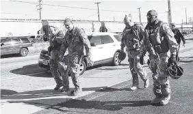  ?? THE ASSOCIATED PRESS ?? Roanoke Sheriff’s Office SWAT team, along with several agencies, respond to a fatal shooting at FreightCar America in Roanoke, Va., on Tuesday.