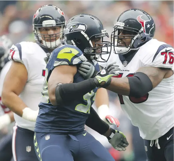  ?? — GETTY IMAGES FILES ?? Seahawks defensive end Dwight Freeney is blocked by Texans tackle Duane Brown, right, during NFL action last Sunday at CenturyLin­k Field. Freeney and Brown will be teammates this weekend after the Seahawks traded for Brown this week.