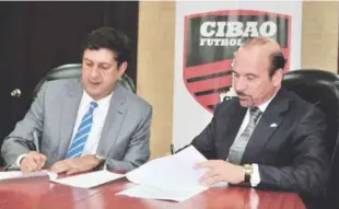  ??  ?? Los señores Manuel Estrella y José Luis Asilis firman el acuerdo entre el Cibao FC y Metro S.T.