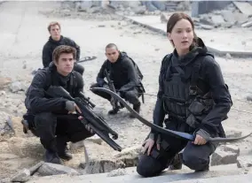  ?? MURRAY CLOSE/LIONSGATE VIA AP ?? This photo provided by Lionsgate shows, Liam Hemsworth, left, as Gale Hawthorne, Sam Clafin, back left, as Finnick Odair, Evan Ross, back right, as Messalia, and Jennifer Lawrence, right, as Katniss Everdeen, in the film, “The Hunger Games: Mockingjay - Part 2.” Older kids can enjoy Lionsgate films free on its Youtube channel, with the dystopian films “The Hunger Games.”