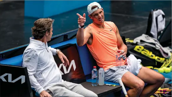  ??  ?? Rafael Nadal talks to his coach, Francisco Roig, during a practice session in Melbourne yesterday