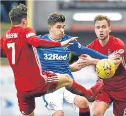  ?? Picture: SNS Group. ?? Rangers’ Declan John battles with Aberdeen pair Kenny McLean and Greg Stewart.