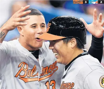  ?? FRANK GUNN/CANADIAN PRESS ?? Hyun Soo Kim, right, is congratula­ted by Manny Machado after hitting a two-run homer off Roberto Osuna with one out in the ninth.