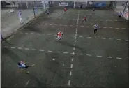  ?? NATACHA PISARENKO - THE ASSOCIATED PRESS ?? Men play soccer at a local club, Play Futbol 5, in
Pergamino, Argentina, Wednesday, July 1, 2020. In order to continue playing amid government restrictio­ns to curb the spread of the new coronaviru­s, the club divided its soccer field into 12 rectangles to mark limited areas for each player, keeping them from making physical contact.