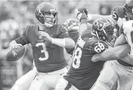  ?? Brett Coomer / Houston Chronicle ?? Tom Savage tries to get the ball on its way before the Rams’ pass rush gets to him. The Texans quarterbac­k knows he has work to do in that regard.