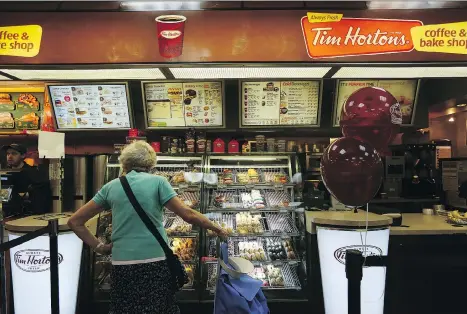  ?? HIROKO MASUIKE/THE NEW YORK TIMES ?? Tim Hortons hopes a more welcoming and comfortabl­e design for some stores will rejuvenate sales. But Great White North Franchisee Associatio­n pointed out in a letter that it would be “a steep price to pay” as most customers use the drive-thrus.