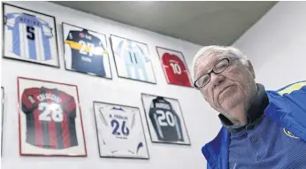  ??  ?? THE HUNTER: Argentinia­n football talent scout Ramon Maddoni poses next to jerseys given to him by football stars he scouted at Club Parque in Buenos Aires.