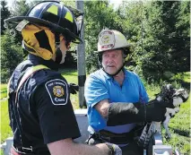  ?? DANIELLE CARDINAL/ OTTAWA FIRE SERVICES ?? Resident Dave Craig, right, and firefighte­r Byron McNeely prepare to return an osprey to its nest.