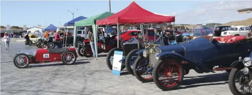  ??  ?? Not your normal pit scene. Steve Aldersley’s supercharg­ed Austin Seven is pushed out ready for action, while Anne Thompson’s 14.25 litre Darracq sits alongside Olivia McNair’s little Delage