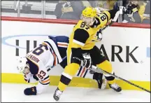  ??  ?? Pittsburgh Penguins’ Sidney Crosby (87) collides with Edmonton Oilers’ Ryan Nugent-Hopkins (93) during the first period of an NHL hockey gamein Pittsburgh, on Feb 13.