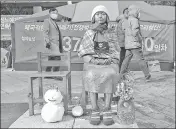  ??  ?? A statue symbolisin­g a wartime sex slave is displayed near the Japanese embassy in Seoul, South Korea.