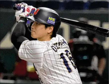  ?? EUGENE HOSHIKO/ASSOCIATED PRESS ?? Shohei Ohtani of Japan hits a double in the fourth inning of a Pool B game against China at the World Baseball Classic in Tokyo on Thursday. Ohtani also struck out five in four scoreless innings.