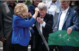  ?? ?? Lynda Oschin and Dr. E.C. Krupp, director of the Griffith Observator­y, cut the ribbon for the new show at the planetariu­m Wednesday.