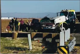  ?? KYMA ?? Law enforcemen­t members work at the scene of a deadly crash involving a semitruck and an SUV in Holtville on Tuesday.