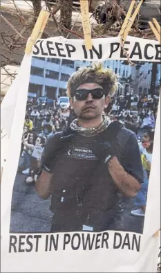  ?? Lori Van Buren / Times Union ?? A T-shirt with the late activist Dan Prouty’s photo on it hangs at an altar near the Sanctuary for Independen­t Media in Troy.