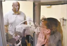  ?? AP photo ?? Respirator­y therapist Vernon Johnson, (left) conducts a pulmonary test on Christine Ekstedt at the Center for Asbestos Related Disease onThursday in Libby, Mont. The clinic has diagnosed thousands of people with asbestos-related disease following contaminat­ion from a nearby mine for vermiculit­e, a product that was shipped across the U.S. by rail for use as insulation and other purposes.