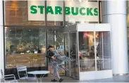  ?? Don Emmert / AFP / Getty Images ?? Starbucks closed more than 8,000 stores across the U.S. to conduct employee training on racial bias.