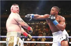  ?? Former world heavyweigh­t champion, Anthony Joshua (R) throws a punch at Luis Ruiz Jr during their first match in the USA. ??