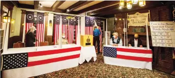  ?? — AFP photo ?? Voters fill out their ballots at the Hale House at the historic Balsams Resort during midnight voting as part of the first ballots cast in the United States Presidenti­al Election in Dixville Notch, New Hampshire.