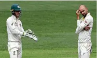  ?? GETTY IMAGES ?? Australian captain Tim Paine, left, and spinner Nathan Lyon, right, were frustrated that so many reviews went against them in the first test.