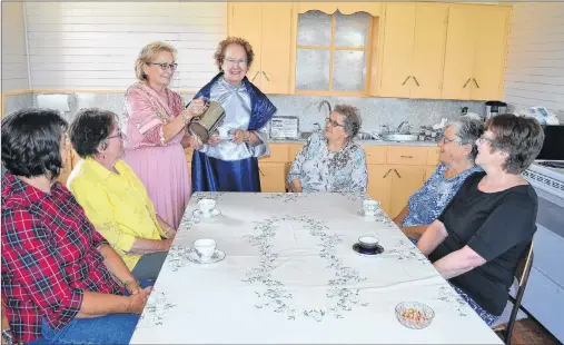  ?? ERIC MCCARTHY/JOURNAL PIONEER ?? Fairley Yeo, standing left and Betty Sweet get in a little practice serving their sister members of the Knutsford Women’s Institute as the group prepares for their Canada 150 Heritage Tea on Sept. 16. Waiting to be served, from left, are Barb Sweet,...