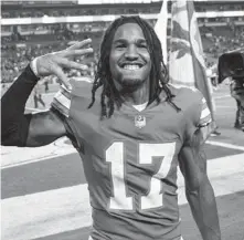  ?? DOUG MURRAY/AP ?? Dolphins receiver Jaylen Waddle is all smiles after a win over the Patriots on Jan. 9 in Miami Gardens.