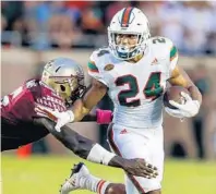  ?? BUTCH DILL/GETTY IMAGES ?? Running back Travis Homer, an Oxbridge Academy alum, is averaging 8.2 yards per carry in his backup roll this season. With Mark Walton out for the year, Homer is now the featured back.