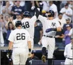  ?? FRANK FRANKLIN II — THE ASSOCIATED PRESS ?? The New York Yankees' DJ LeMahieu (26) looks on as Anthony Rizzo (48) celebrates with Aaron Judge after Rizzo hit a three-run home run during the first inning of Monday's game.