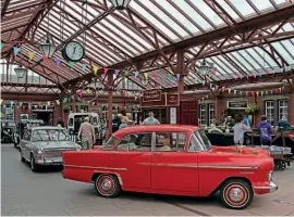  ??  ?? Classic cars on the concourse inside Kiddermins­ter Town station.
