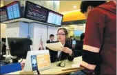  ?? GAO ERQIANG / CHINA DAILY ?? A business owner applies for a license at the Government Affairs Center of the Free Trade Zone of Pudong New District, Shanghai, on Nov 28.