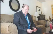  ?? CP PHOTO ?? Rick Brown sits in his living room with a small Bible in Kitchener Ont.