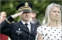  ?? ?? Saluting during the ceremony is Army Chaplin Rev. Andrzej Andrew Tenus with the Polish National Catholic Church. Standing in front of him is Fitchburg City Council member Sam Squailia.