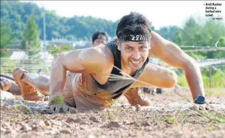  ?? HT PHOTO ?? ▪ Amit Kadian during a barbed wire crawl.