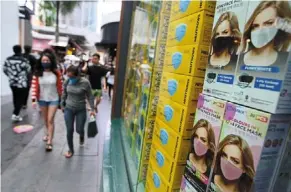  ?? ?? Keeping safe: People donning face masks for their protection in bukit bintang, Kuala Lumpur. — azman Ghani/the Star